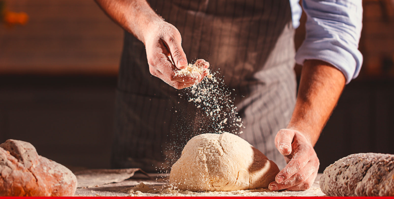 Baker kneads bread dough